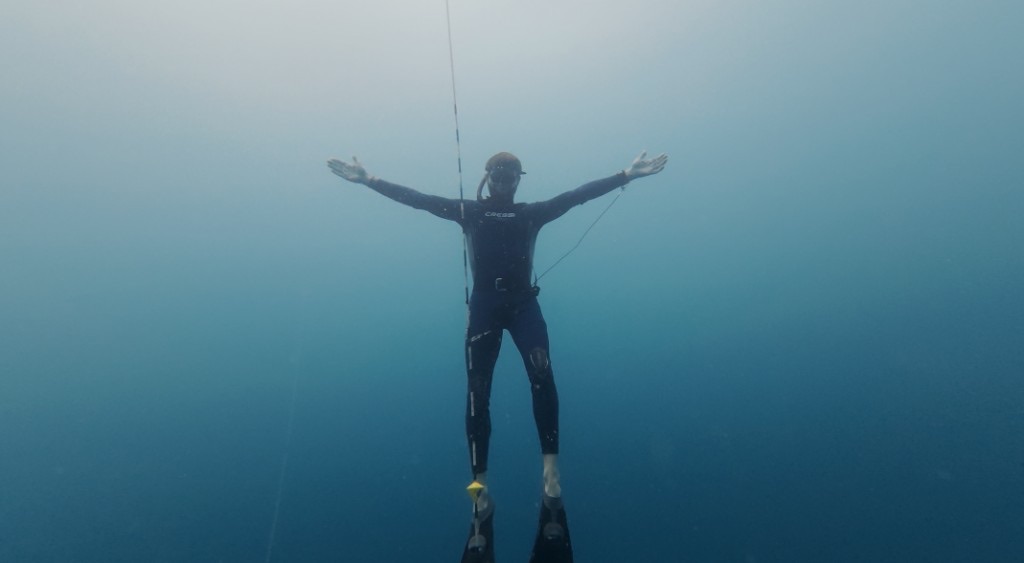 Freediver in open blue water